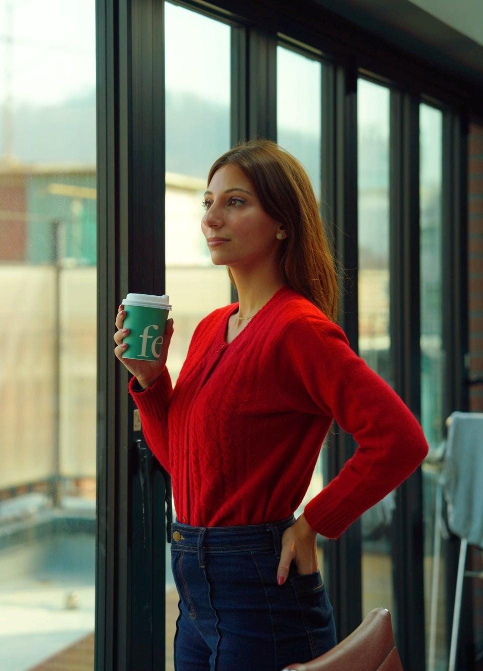 Raquel with a coffee in the lounge at Cove Seongsan